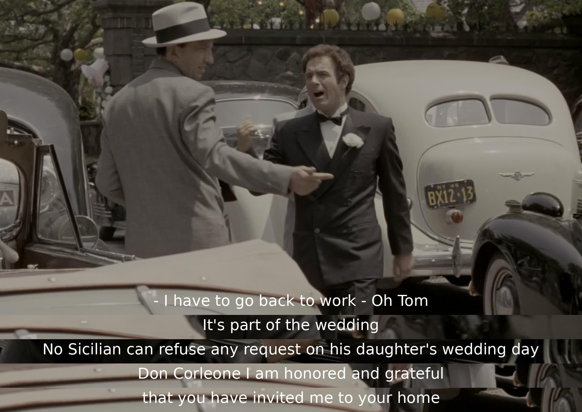 A man named Tom is reluctant to leave work but attends a wedding, showing respect for Sicilian tradition. He is grateful for the honor of being invited to Don Corleone's home.