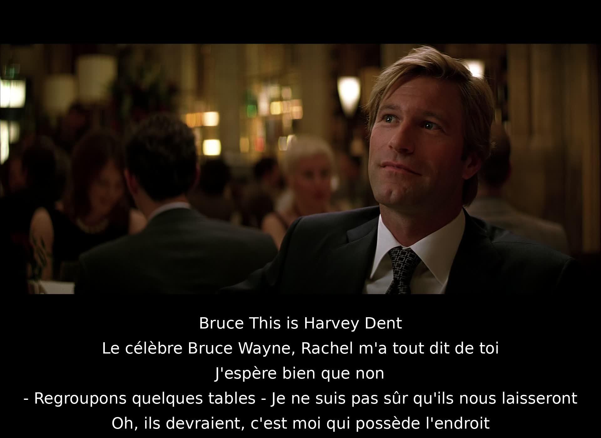 Bruce introduces Harvey Dent to a woman named Rachel. They plan to move tables but are unsure if they'll be allowed. Bruce assures them it should be fine as he owns the place.